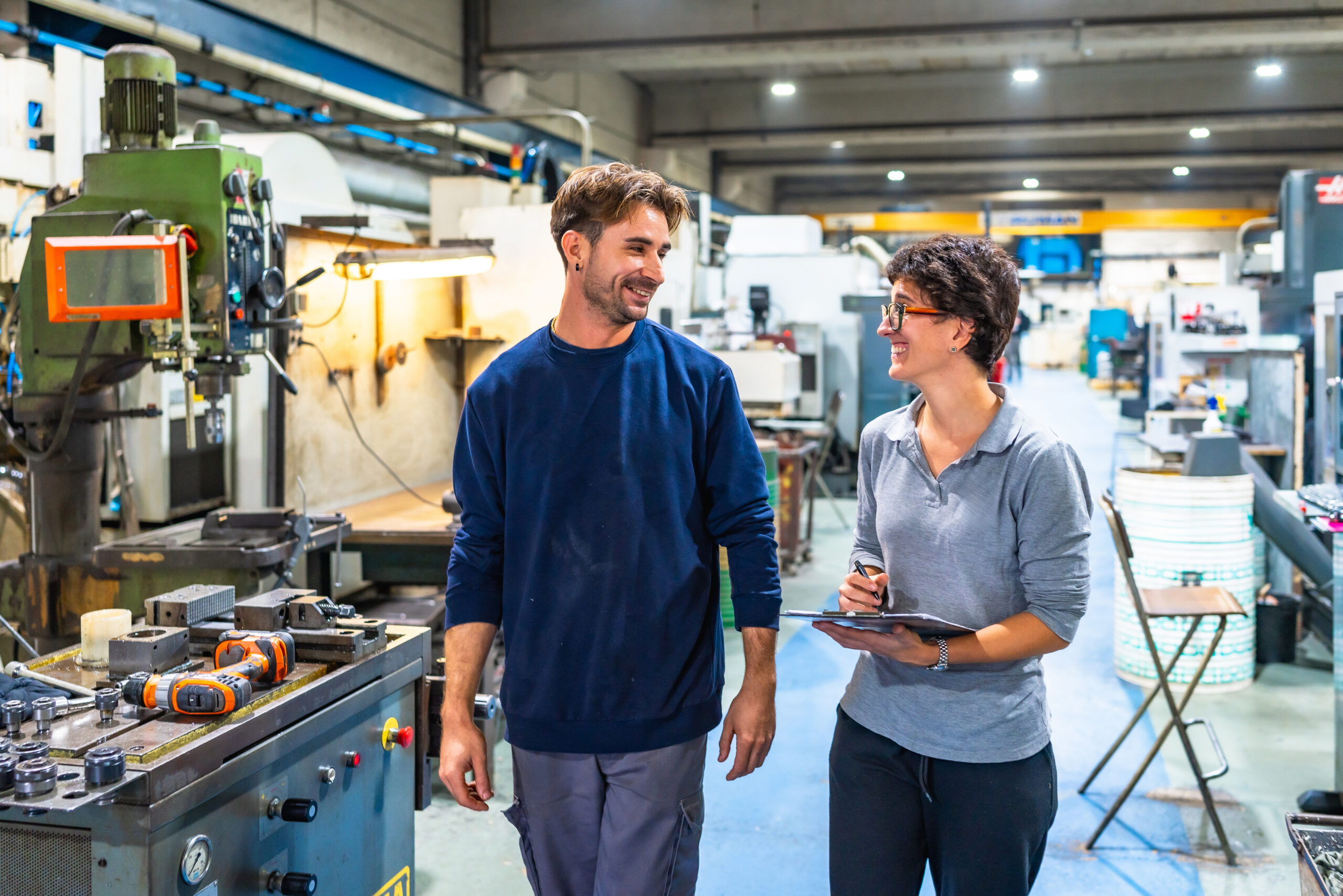 worker and manager talking in a small factory