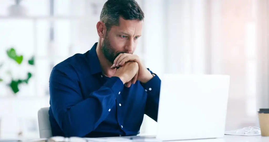 Shot of a businessman looking anxious in his office at work. Layoutoptimierung: Shot of a businessman looking anxious in his office at work.