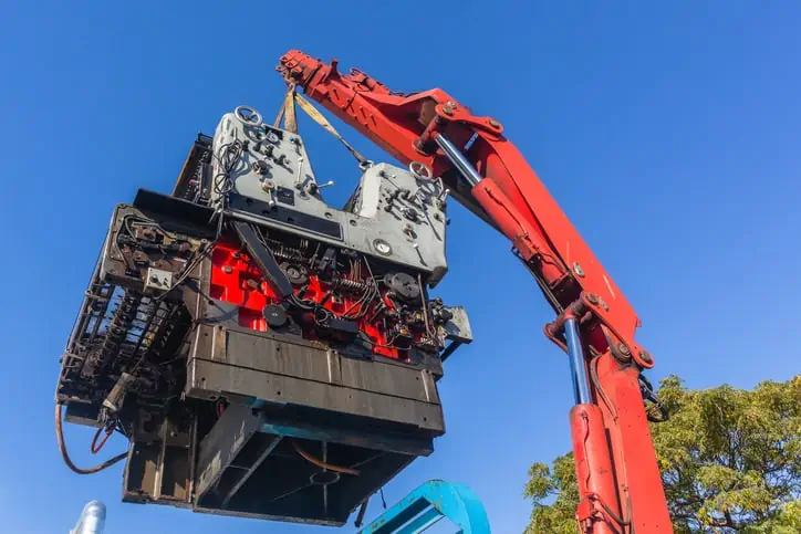 loading of heavy machinery by a crane