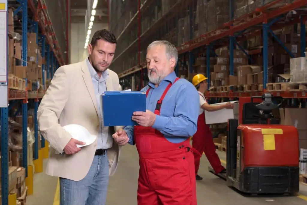 Inspection of the stock levels in the factory on site by two employees