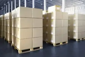 Block storage with cartons on pallets in a warehouse